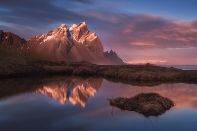 A mountain and it's reflection in the clear still waters of East Iceland.