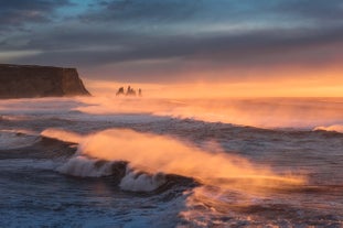 Huge waves roll in from the Atlantic ocean on the black sands of Iceland's South Coast.