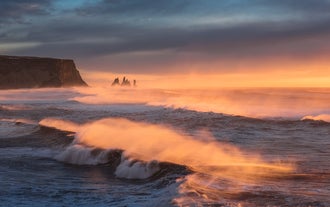 Huge waves roll in from the Atlantic ocean on the black sands of Iceland's South Coast.