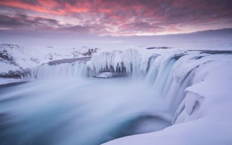 The waterfall, Goðafoss, frozen in the wintertime.