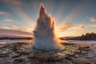 Capture the moment the hot spring Strokkur erupts at Geysir geothermal area.