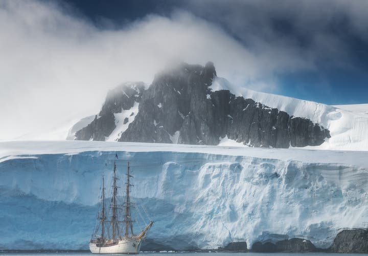 The Greg Mortimer sails along the Antarctic ice shelf.