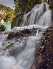Water surges down a waterfall at Plitvice Lakes National Park.