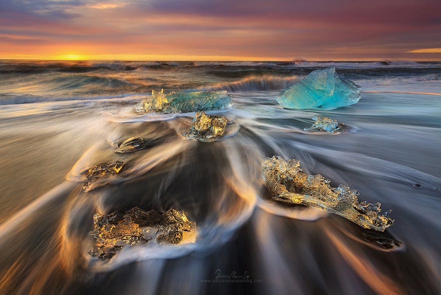 Waves swirl around ice on the beach during a long exposure scene - Iceland Photography | Everything You Need To Know