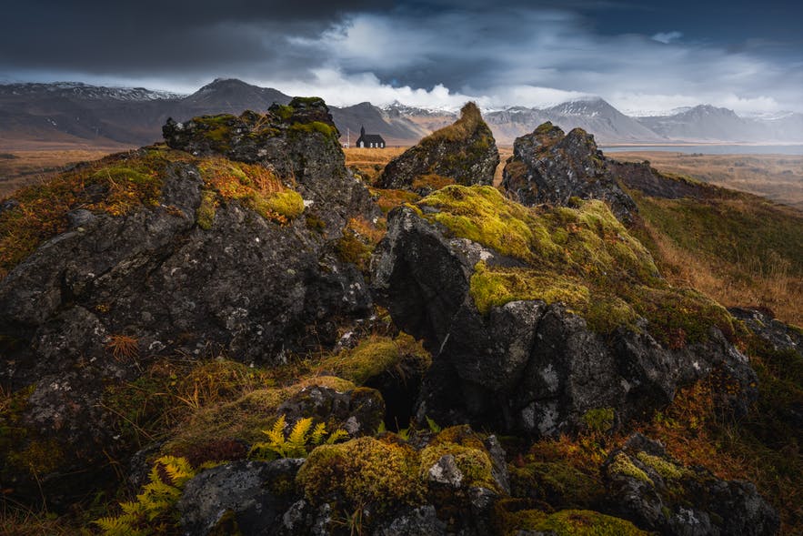 A church sits between rocks in an Icelandic landscape - Iceland Photography | Everything You Need To Know