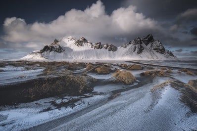 Northern Lights dancing over the dramatic Vestrahorn mountain.