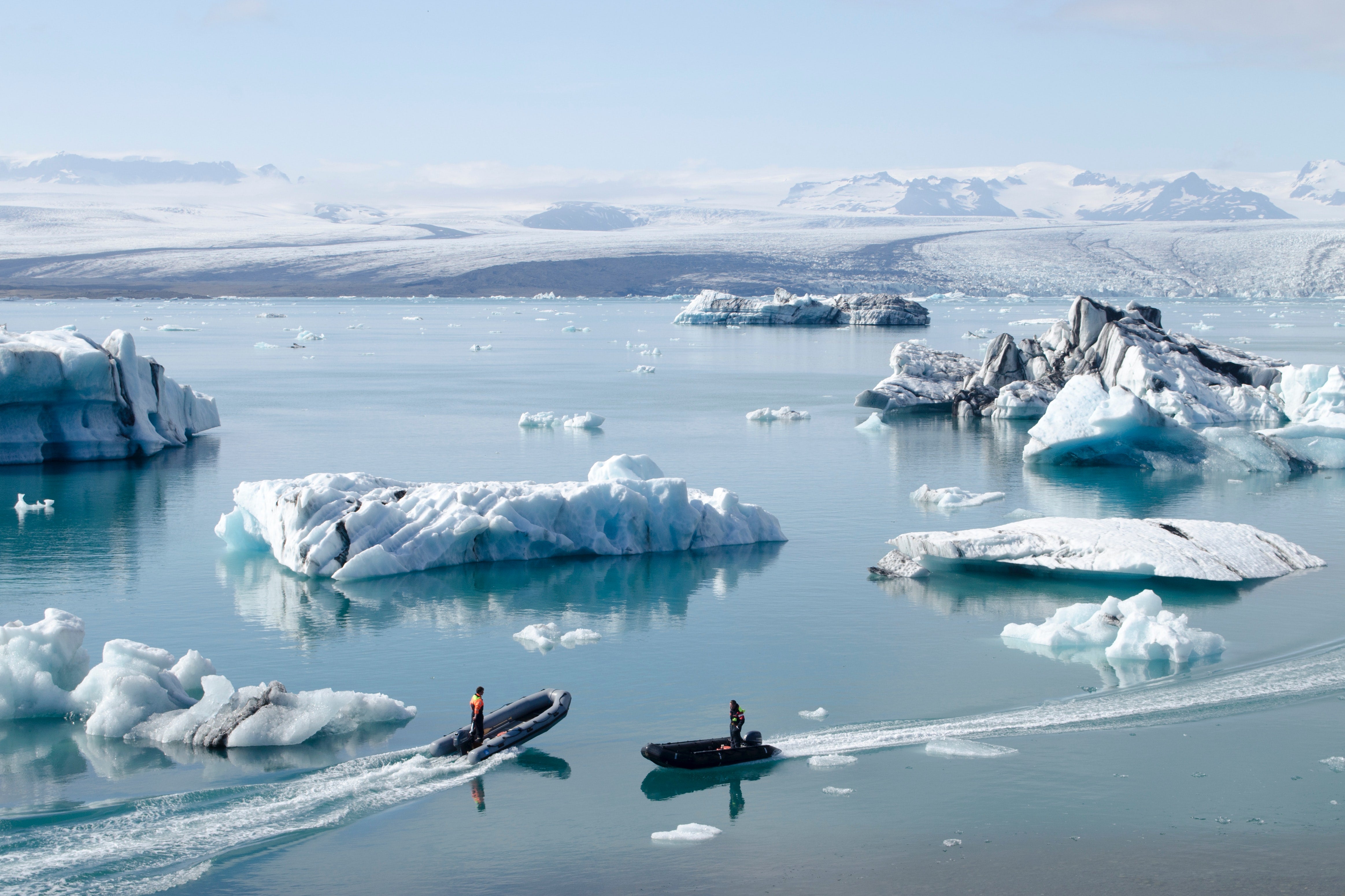 Two men on boats in Iceland water.