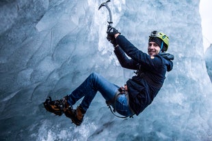 A man conquering the icy heights of the glacier.