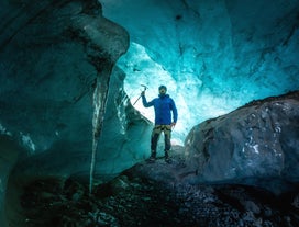 Exploring the enchanting Blue Ice Cave, a moment of awe in nature's frozen masterpiece.