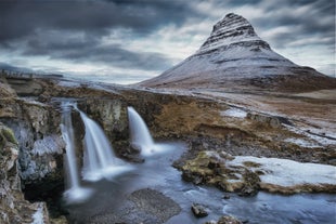 Capture the perfect shot of Kirkjufell Mountain alongside the mesmerizing cascading waterfall, creating a stunning natural spectacle.