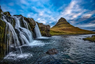 Discover the harmonious blend of rugged mountains, lush greenery, and cascading waterfalls that make Kirkjufell Mountain a true masterpiece of nature.