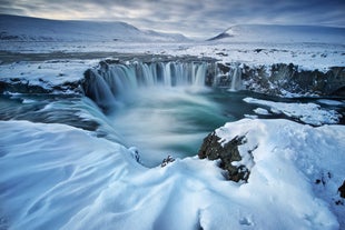 Winter wonderland at Godafoss waterfall, where the cascading water transforms into a frozen masterpiece.