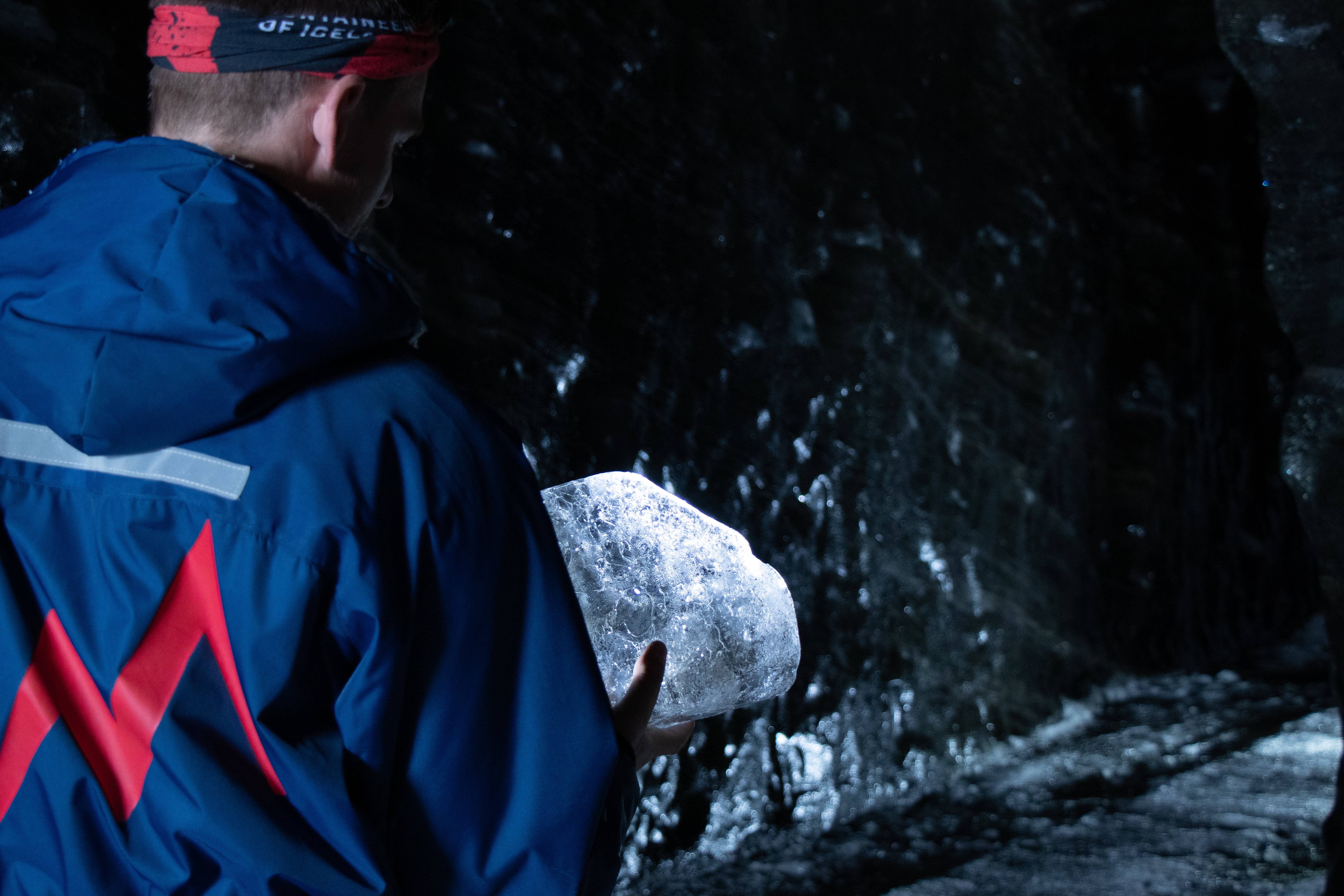A person holds a glistening ice chunk in the Langjokull ice tunnel.