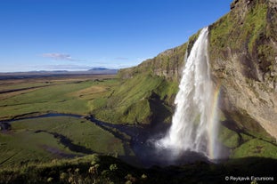 Seljalandsfoss is a picture-perfect waterfall on Iceland's South Coast with a path encircling it.