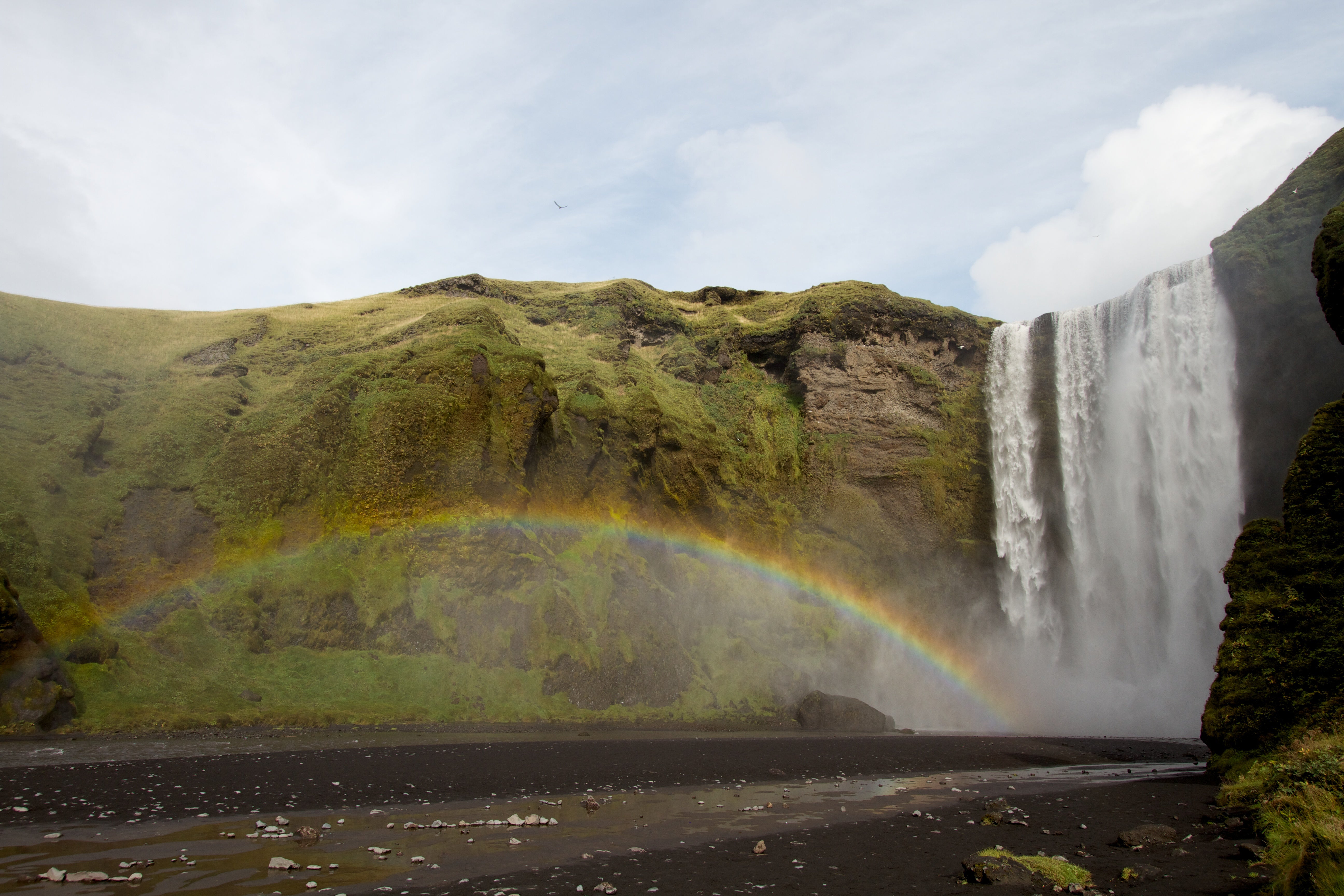 Skogafoss, a beautiful and powerful South Coast waterfall, boasts a rainbow on sunny days.