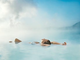 A woman relaxes at the Blue Lagoon geothermal spa in Iceland.