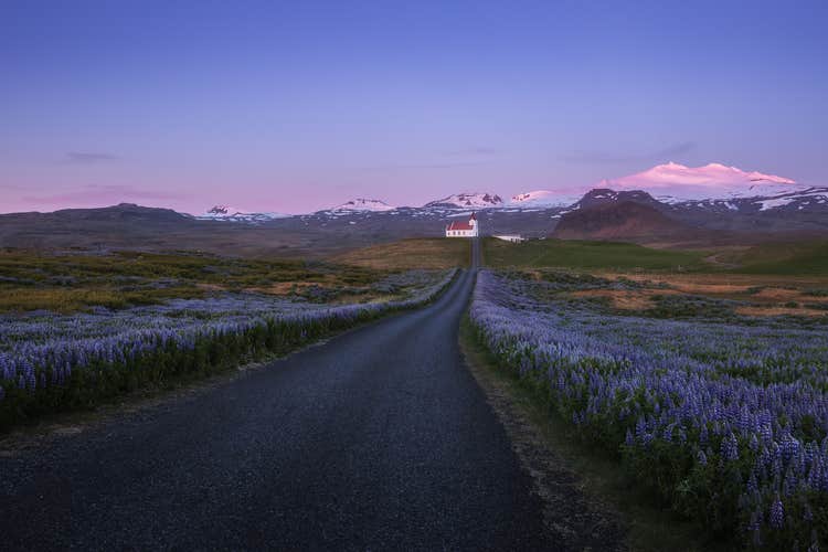 The church of Budir stands before the Snaefellsjokull glacier.