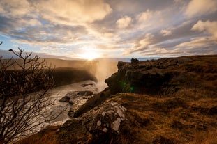 People stand overlooking Gullfoss waterfall on Iceland's Golden Circle route.