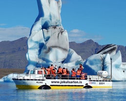 A group of tourists enjoying a boat tour in the Jokulsarlon glacier lagoon.