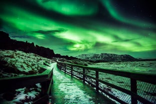 The aurora borealis illuminating a viewing deck in Iceland.