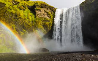 A rainbow can often be seen above the cascade of Skogafoss waterfall.