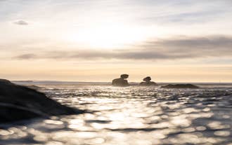 People bathe in the picturesque Sky Lagoon geothermal spa near Reykjavik at dusk.