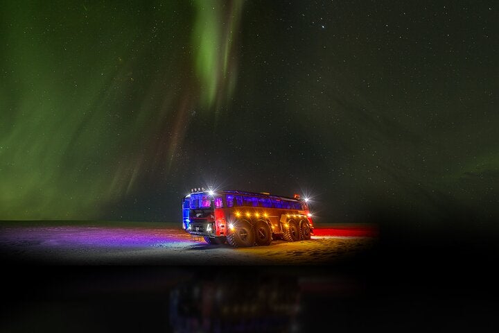 Roaming beneath the dancing lights of the aurora, the illuminated monster truck adds a touch of magic to the night.
