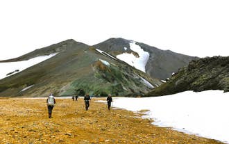 Adventurers hiking along the beautiful trails of Landmannalaugar in Iceland.