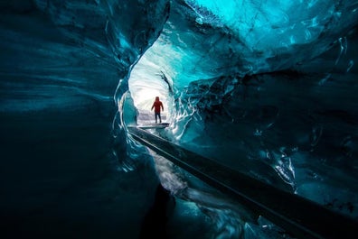 Explore the mystical ice caves beneath the formidable Katla Volcano, where fire and ice unite in an otherworldly spectacle.