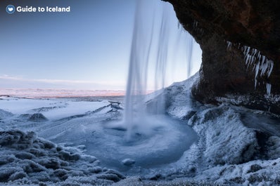 Seljalandsfoss waterfall looks like something from a fairytale, whether you visit in summer or winter.