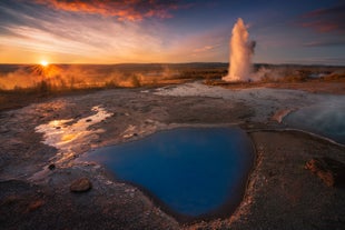 The Geysir geothermal area looks stunning under the colors of the setting sun.