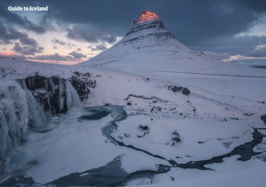 Kirkjufell mountain and the Kirkjufellsfoss waterfall look breathtaking in their snowy winter coat.