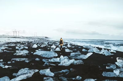 Glistening diamonds scattered along the black sand shore, creating a mesmerizing contrast at Diamond Beach.