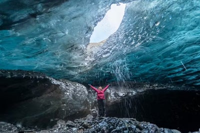 Explore the mesmerizing depths of a stunning blue ice cave, where nature's frozen artistry comes to life.