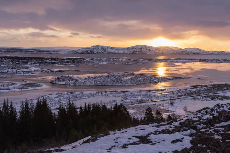The sun sets over a winter landscape in Southwest Iceland.