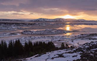 The sun sets over a winter landscape in Southwest Iceland.