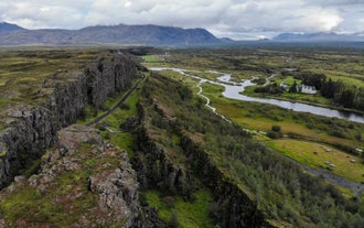 Thingvellir National Park boasts an enchanting landscape of lush greenery and geological wonders.