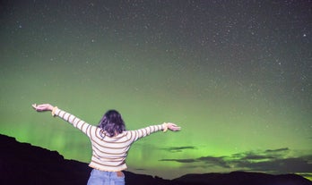 The aurora borealis paints the Icelandic skies with green lights.