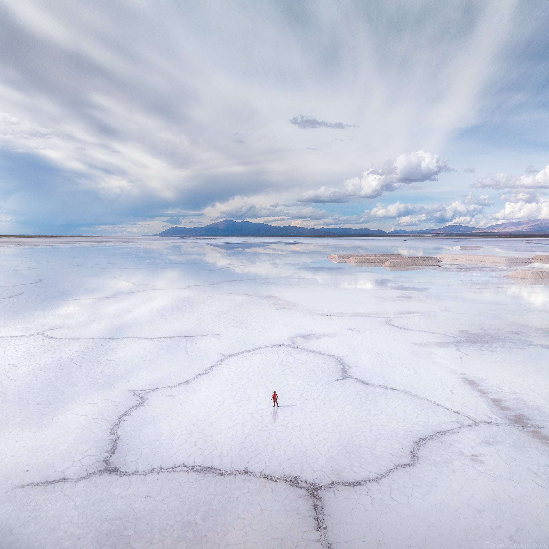 Clouds reflect in the salt flat of Sala de Arizaro.
